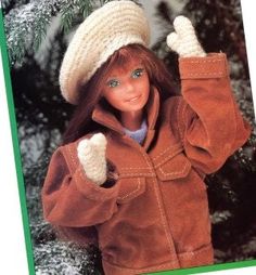 the doll is wearing a brown jacket and hat with her hands up in the air