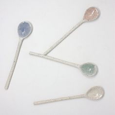 four spoons with speckled designs on them