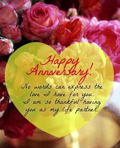 a vase filled with pink flowers and a yellow heart shaped sign that says, happy anniversary no words can express the love if for you