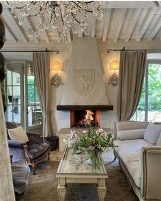 a living room filled with furniture and a fire place in the middle of a room