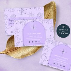 two purple business cards with gold foil on them and a golden leaf next to it