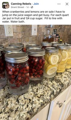 jars filled with cherries and lemons sit on a counter