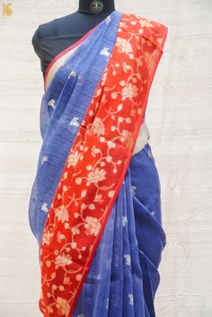 a blue and red sari with flowers on it