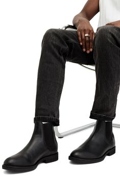 Elevate your closet staples with this sleek leather Chelsea boot featuring Western-inspired paneling at the heel and a rugged rubber sole. 5 1/2" shaft Lace-up style Leather and textile upper and lining/rubber sole Made in Portugal Casual Black Boots With Leather Lining, Fitted High Ankle Boots With Lug Sole, Casual Chelsea Boots In Calf Leather With Plain Toe, Business Winter Chelsea Boots With Rubber Heel Cap, Classic Chelsea Boots With Lug Sole For Work, Classic Leather Boots Medium Width, Casual Fitted Boots With Rubber Heel Cap, Fitted High Ankle Black Chelsea Boots, Fitted Leather Heeled Boots In Casual Style