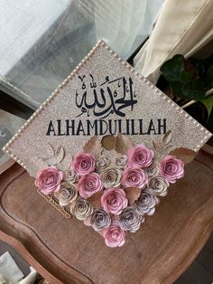 a graduation cap decorated with pink and white flowers