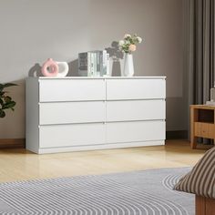 a white dresser sitting on top of a hard wood floor