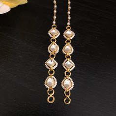 Kundan Earring Support Chain/ Golden Ear Chain/ Kundan Earrings Support Chain/ Kaan Chains/ Earrings Sahara / Jewelry Accessories/ Maatal Features: Made in Brass with 22 Karat Gold plating with Kundan Stones Pair of Two Earrings Support Chains - One for each Ear Used for Earrings Support  Approx. 5 to 5.5 Inches in Length Best support chain for earrings, Studs, Chandbali, and Jhumkas Easy to attach to earrings Temple Jewelry Style Earrings With Pearl Chain For Gift, Temple Jewelry Style Earrings With Pearl Chain, Temple Jewelry Earrings With Pearl Chain For Festivals, Gold Pearl Chain Jewelry For Festivals, Metal Pearl Chain Earrings As Gift, Pearl Chain Earrings As A Gift For Festivals, Traditional Gold Earrings With Pearl Chain, Pearl Chain Metal Earrings For Weddings, Metal Earrings With Pearl Chain As Gift