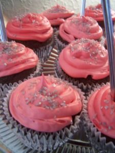 cupcakes with pink frosting and silver sprinkles