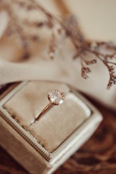 an engagement ring sitting on top of a box