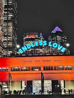 people are standing in front of a large building with the word'biders love'lit up on it