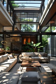 a living room filled with lots of furniture under a glass roof over looking the outdoors