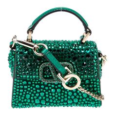 Valentino Garavani Emerald Green Vsling Micro Bag @Valentino Valentino Crossbody Bag Green Leather Gold-Tone Hardware Flat Handle & Single Adjustable Shoulder Strap Leather & Crystal Accents Leather Lining Snap Closure At Front Protective Feet At Base Estimated Item Measurements Shoulder Strap Drop: 21" Handle Drop: 0.75" Height: 3.75" Width: 4.5" Depth: 1" Luxury Green Evening Bag With Detachable Handle, Luxury Green Shoulder Bag For Evening, Designer Embellished Crossbody Bag, Designer Embellished Bags For Shopping, Luxury Green Crossbody Evening Bag, Luxury Green Evening Bag With Dust Bag, Luxury Embellished Shoulder Bag For Shopping, Designer Party Shoulder Bag With Top Carry Handle, Luxury Green Handheld Evening Bag