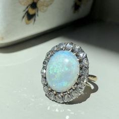 Opal Ring Golden brass Ring blue stone ring victorian ring | Etsy Vintage White Cluster Ring With Gemstone, Antique Style Gemstone Cluster Promise Ring, Antique Gemstone Cluster Ring For Promise, Vintage Moonstone Ring With Rose Cut Diamonds, Vintage Moonstone Promise Ring, Vintage Wedding Moonstone Cabochon Ring, Vintage Opal Gemstone Ring For Wedding, Vintage Opal Ring For Wedding, Elegant Brass Rings With Cabochon