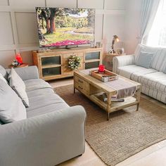 a living room filled with furniture and a flat screen tv on top of a wall