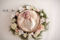 a baby in a basket surrounded by flowers