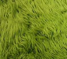 the green fur is very soft and shaggyly textured with it's bright colors