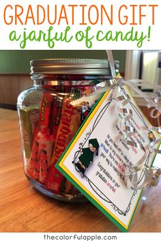 a jar filled with candy and graduation gifts