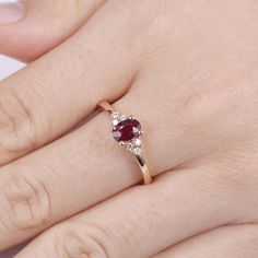 a woman's hand with a ring on it and a stone in the middle