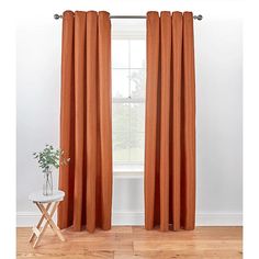 an orange curtain hanging in front of a window