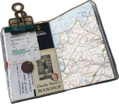 an open book with a map and keys attached to it