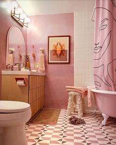 a bathroom with pink walls and checkered flooring