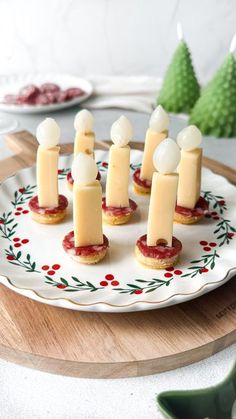 small appetizers are arranged on a platter with red and white decorations around them