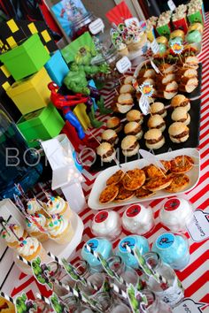 a table topped with lots of desserts and cupcakes