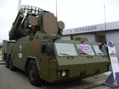 an army vehicle parked in front of a building