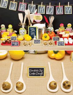 there are spoons on the table with food and signs in front of them that say happy birthday