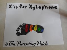 a paper sign with the words x is for xylopne on it and a hand print