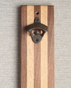 a bottle opener mounted on a wooden board