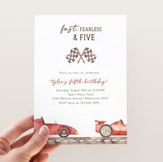 a person holding up a card with a car on it and the words first fearless & five