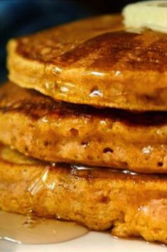 stack of pancakes with butter and syrup on top