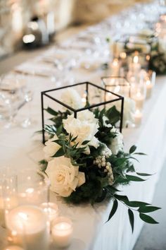 a table with candles and flowers on it