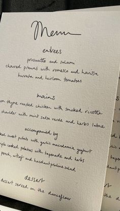 the menu is written in cursive writing on white paper with black inks