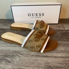 Brand New Guess Hammi Sandal Woman’s Size-7.5 Color- Brown Upgrade Your Grab-And-Go Footwear Collection With The Stylish Hammi Sandal By Guess. This Flat Sandal Has Gorgeous Logo Stitch Work And Accent, Giving Off An Iconic Look. An Elegant Almond Open-Toe Finishes Off The Sleek Design. Cushioned Flip Flops For Outings, Summer Slides For Outings, Cushioned Footbed Flip Flops, Flat Flip Flops With Branded Insole For Vacation, Summer Flat Synthetic Mules, Brown Slides With Branded Insole, Brown Flat Heel Slides For The Beach, Brown Flat Heel Slides For Beach, Brown Flat Heel Beach Slides