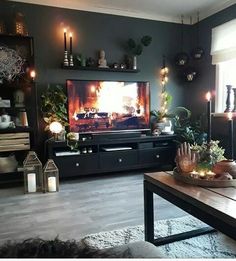 a living room filled with furniture and a flat screen tv sitting on top of a wooden table