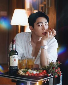 a man sitting at a table with food and drinks