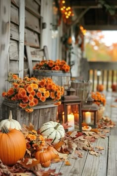 pumpkins and gourds are on the porch