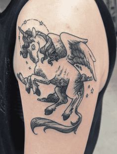 a man with a tattoo on his arm has an image of a horse and angel