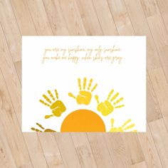 a white card with yellow handprints on it and the words you are my sunshine