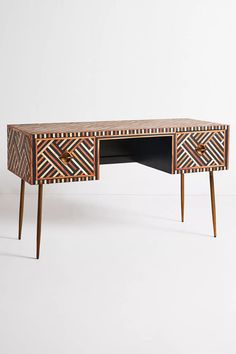 a wooden desk with geometric designs on it