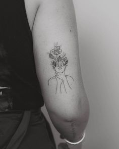 a woman's arm with a flower tattoo on the left side of her arm