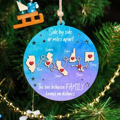 a christmas ornament hanging on a tree with ornaments around it that says, sale by side or miles apart the love between family knows no distance