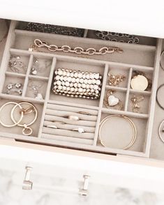 an open jewelry box filled with lots of rings and bracelets