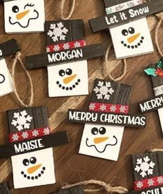 christmas decorations made from wood planks with snowmen on them