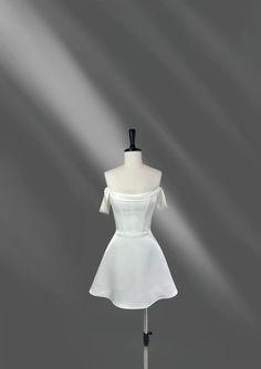 a white dress on a mannequin stand