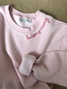 Mamas favorite names hand stitched in red thread on a cozy faded pink sweatshirt. Add a special touch with hearts on the sleeve or collar - one heart for each little one :) Sweatshirts are Unisex sizing and run true to size. I suggest sizing up for a more oversized fit. 70/30 cotton/polyester 3-End fleece, ring spun cotton *Please note that all sweatshirts for this listing are for faded pink long-sleeved crewneck with set-in rib neckband, cuffs & hem band. If you are looking for a specific c