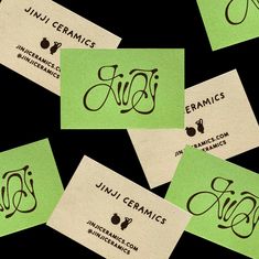 several business cards with green ink on them