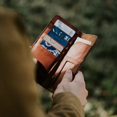 a person holding an open wallet in their hand